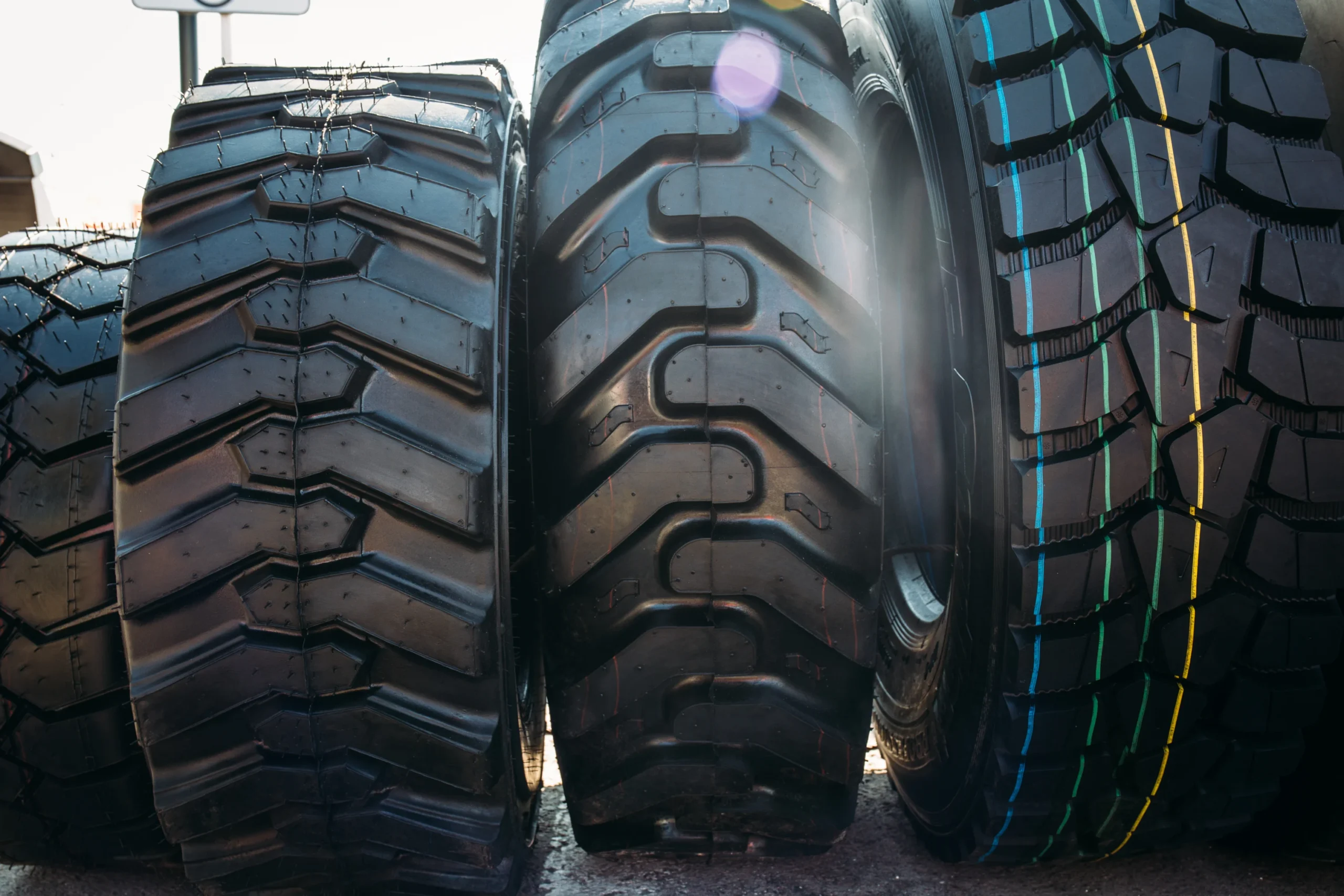 A closeup shot of a row of tires with different treads A closeup shot of a row of tires with different treads
